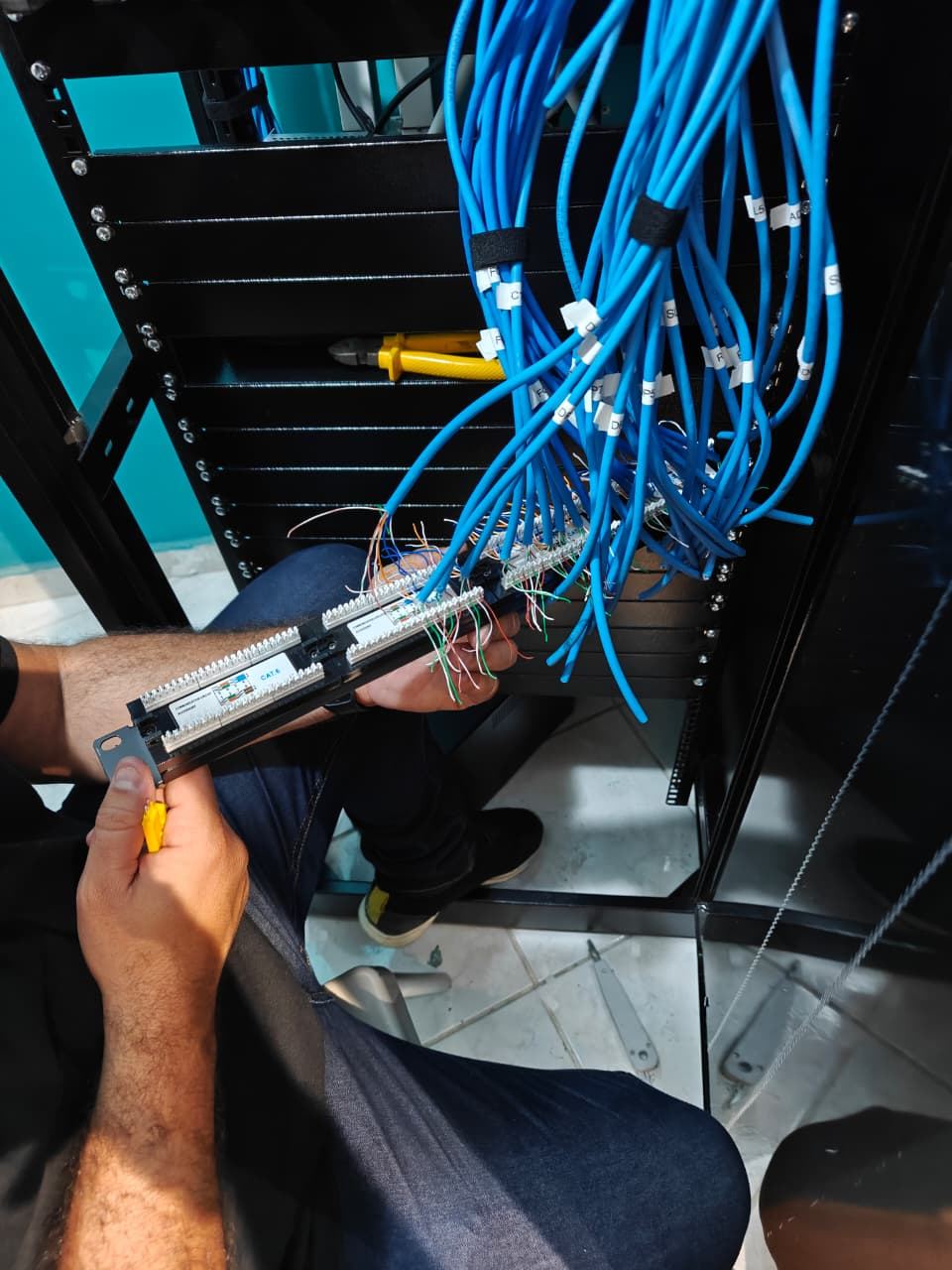 Conexão dos cabos Cat6 ao patch panel com ferramenta de crimpagem